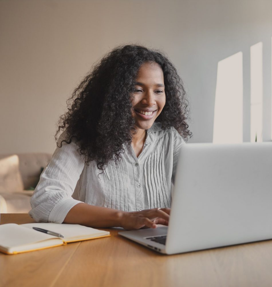 cheerful-young-african-american-woman-copywriter-sitting-front-open-laptop-with-mug-copybook-desk-feeling-inspired-working-new-motivation-article-people-occupation-creativity (1)