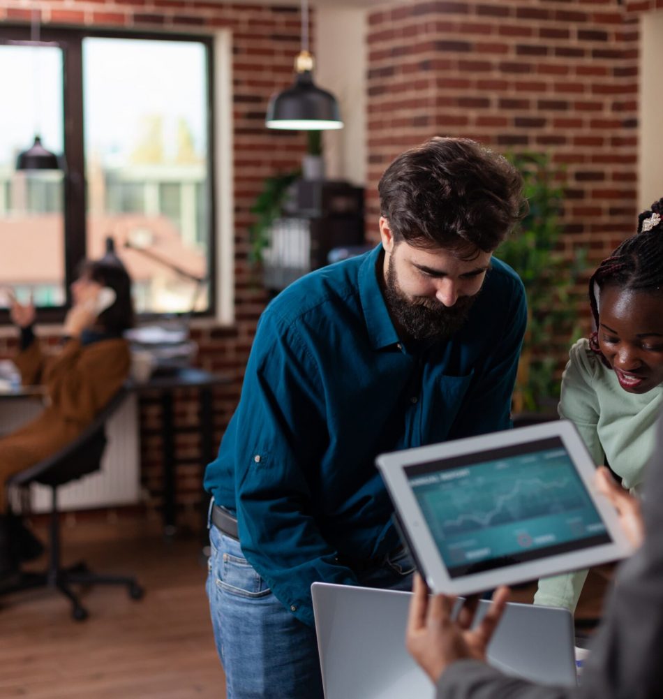 multiracial-businesspeople-holding-tablet-computer-with-marketing-turnover-screen-working-company-project-discussing-business-strategy-working-startup-office-diverse-team-brainstorming-ideas (1)