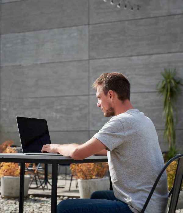 young-man-is-typing-laptop-outdoor (1)